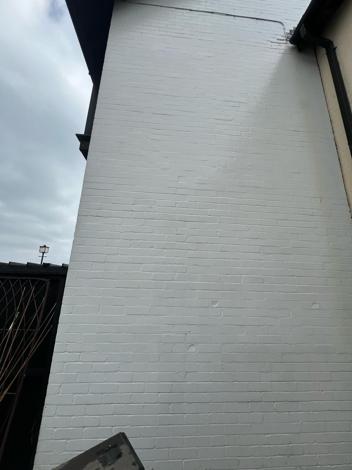 The same wall bright white after a soft wash by D&J Window Cleaners