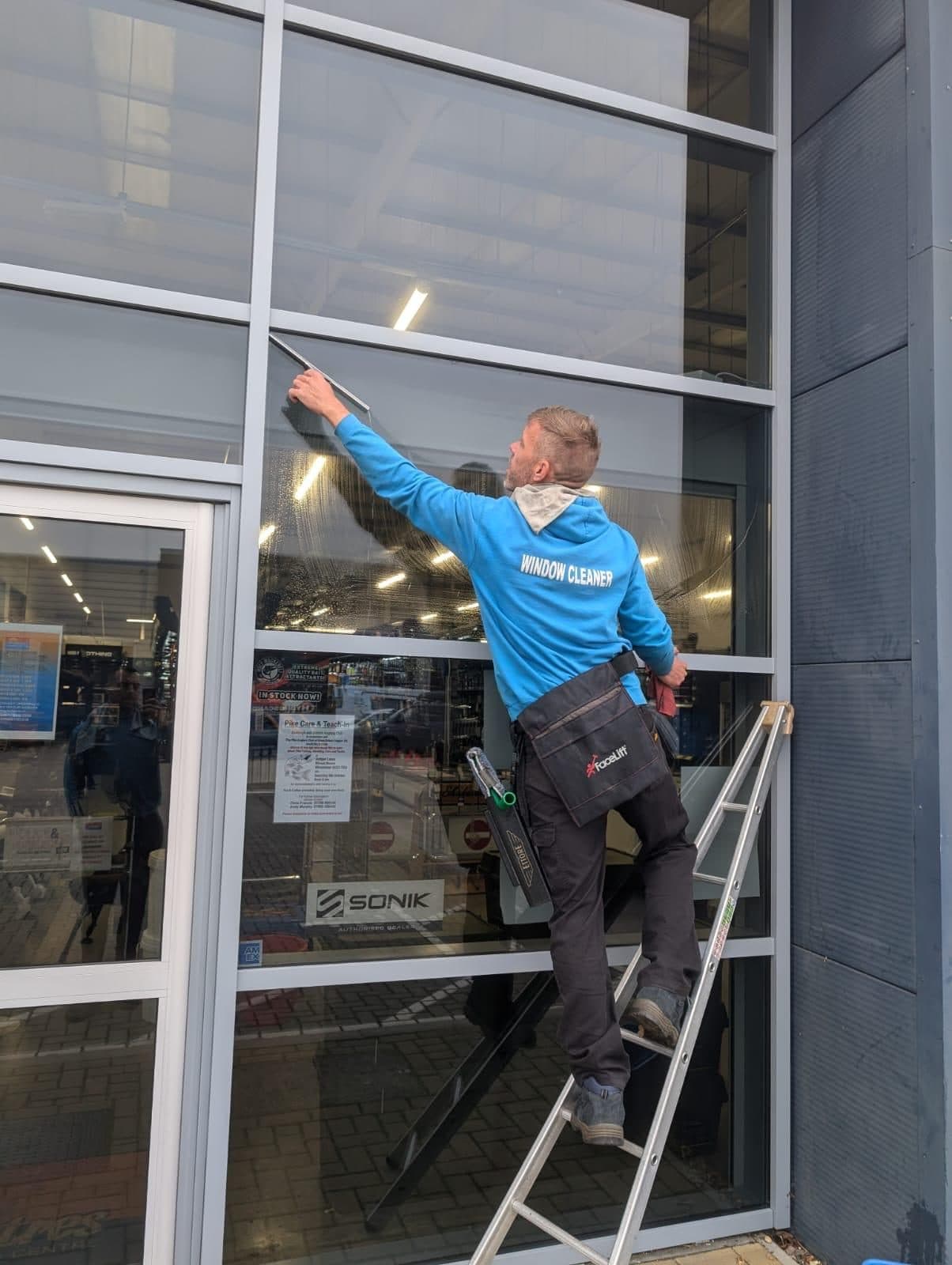 Storefront window cleaning at a retail unit
